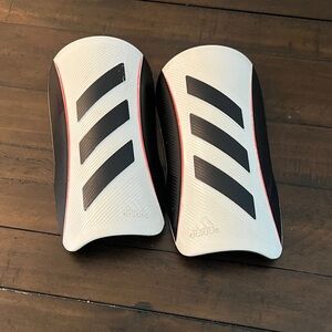 Adidas Black and White Shin Guards with Red Accents